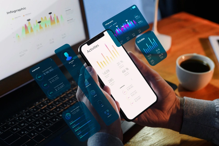 Os melhores aplicativos de finanças para 2025 17 Pessoa utiliza app de controle de finanças. Símbolos gráficos digitais aparecem na tela. Falando sobre os melhores aplicativos de finanças.