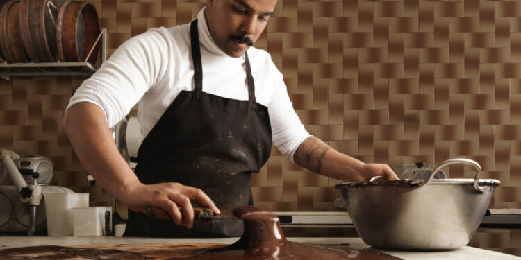 Chocolatier trabalhando em deliciosas criações para renda extra na Páscoa.
