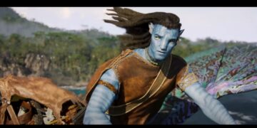 Avatar 3: Personagem masculino com pele azul e trajes tribais, observando o horizonte em ambiente natural.